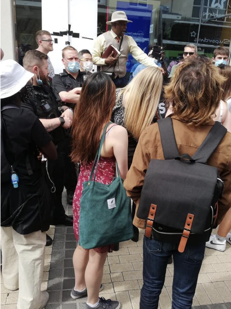 A crowd gathered around a street preacher