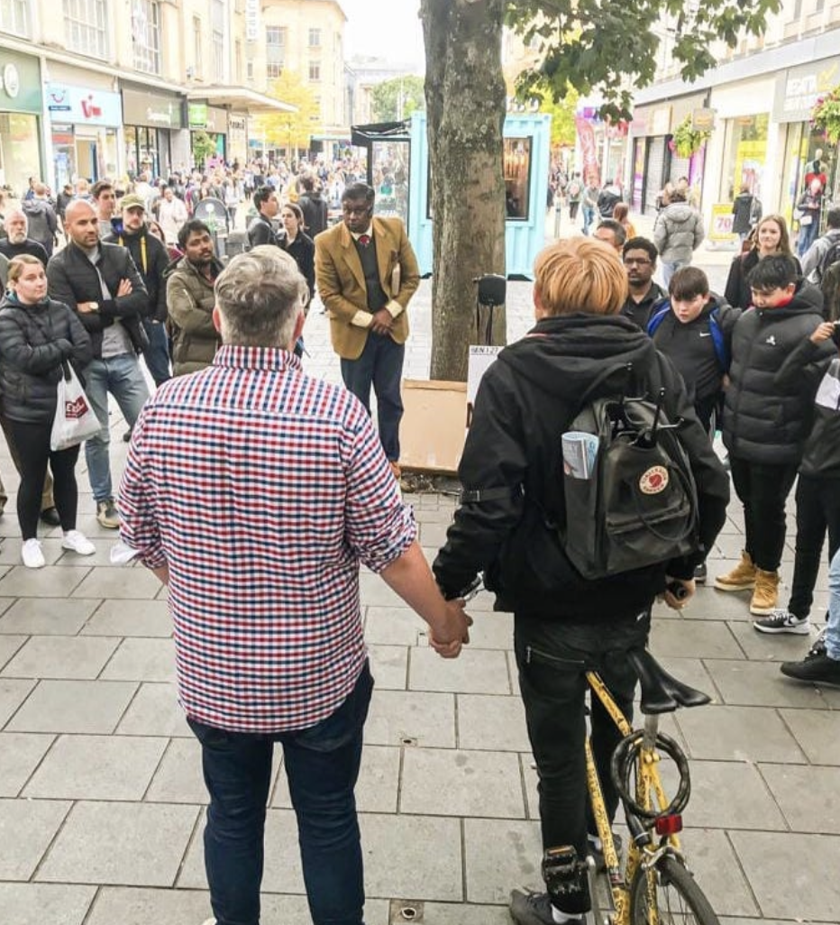 People standing together in a city street during a gathering